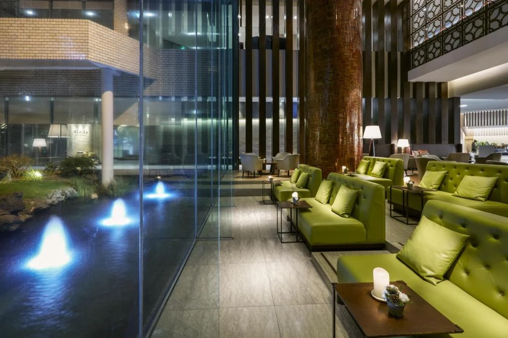 Lounge seating beside an indoor water feature.