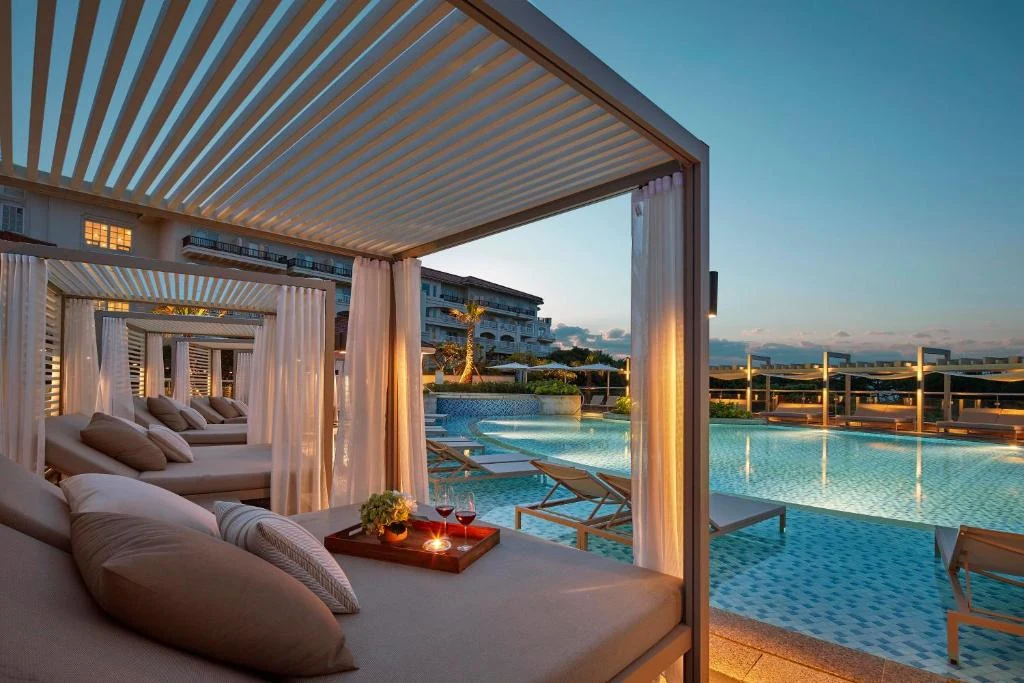 Cabanas beside an outdoor pool at a Jeju seaside resort