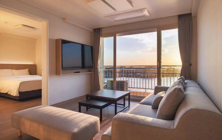Real living room and balcony of an exact-property page Ocean View Suite at Kensington Resort Jeju Hanlim