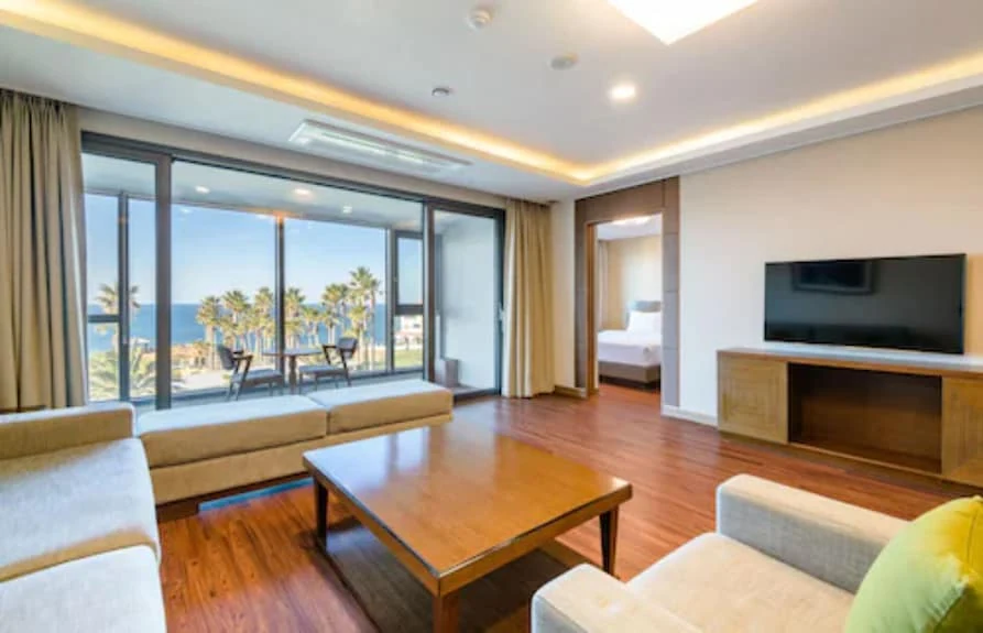 Real property page Uni Hotel Jeju Family Suite living room and separate sleeping space