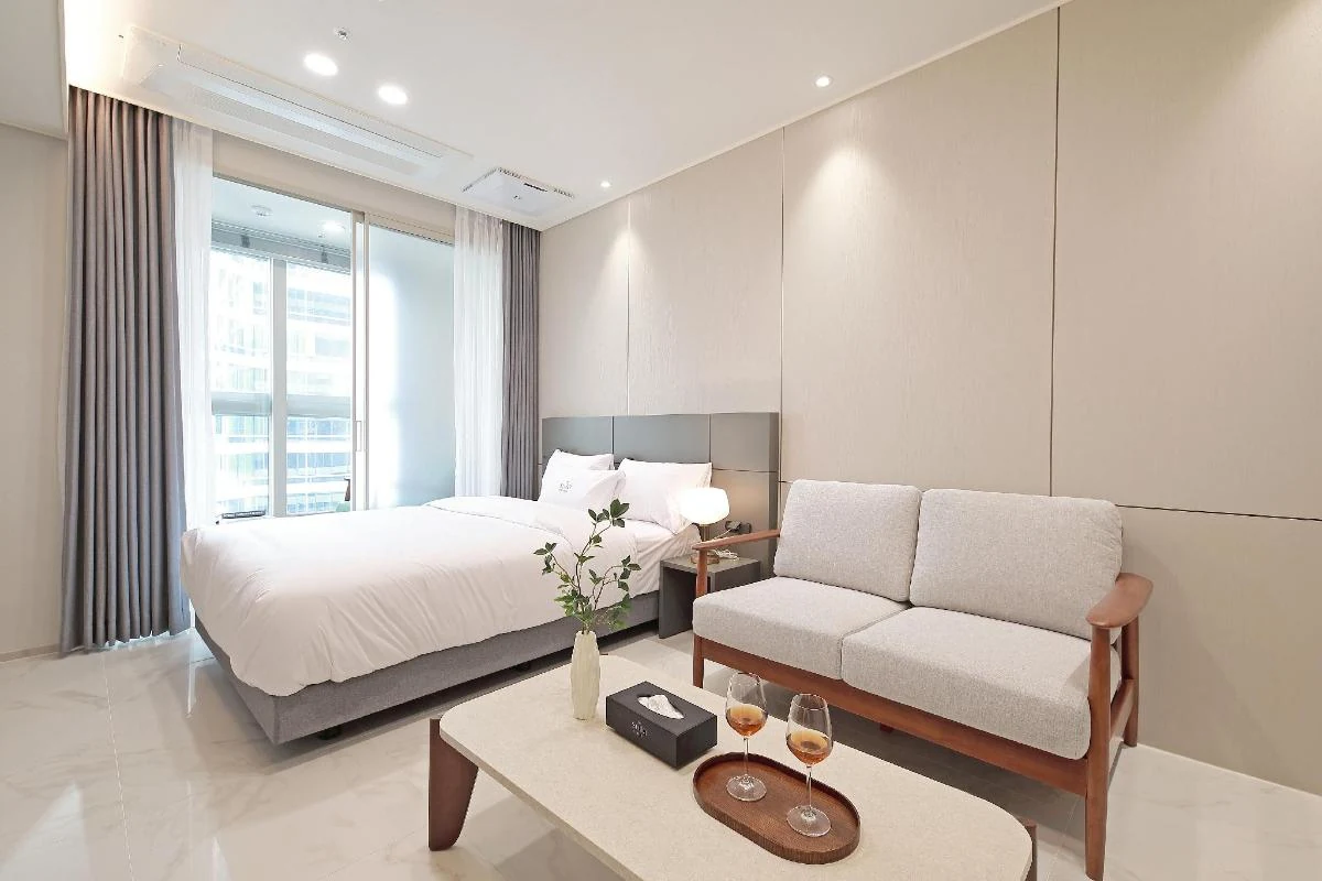 SOTA Suite Busan Seomyeon room with bed, sofa and living space.