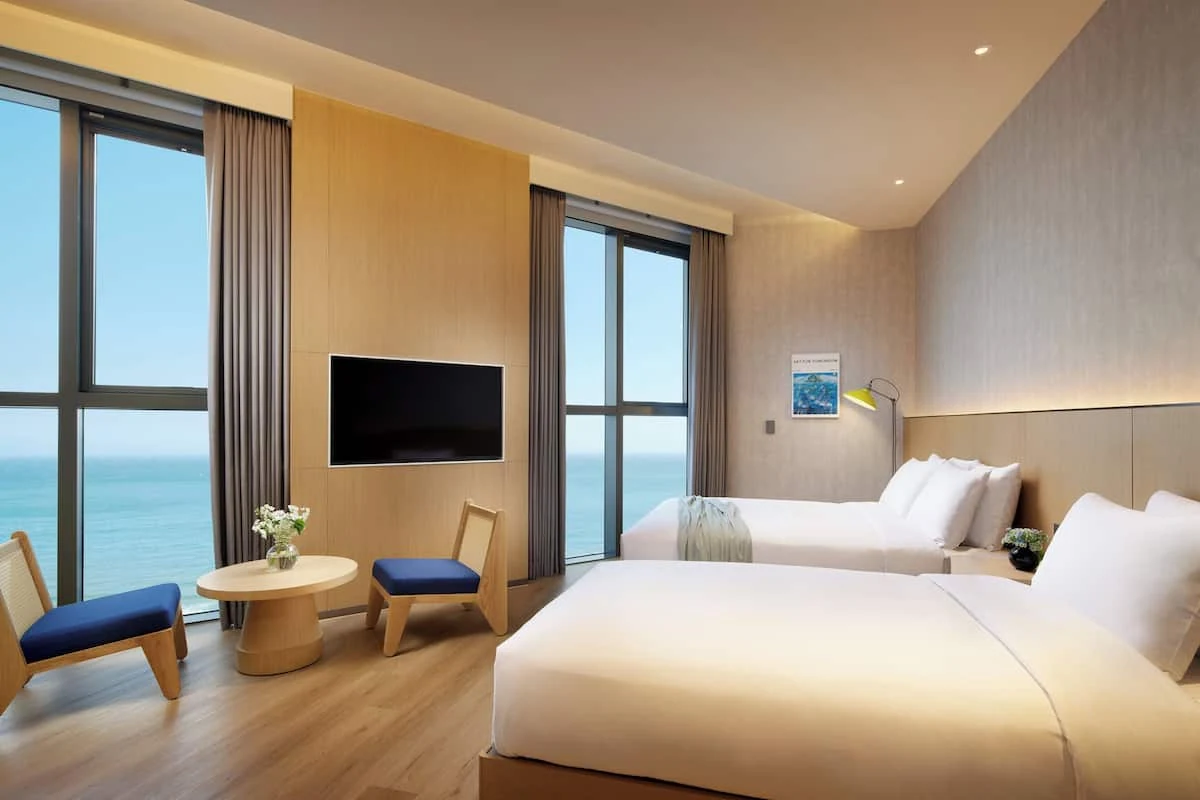 L7 Haeundae authentic room photos: you can see two beds and a sea-view window.