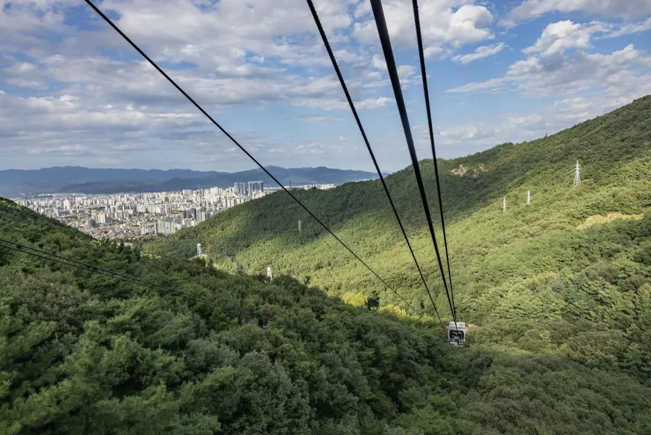 Apsan cable car climbing toward the Daegu skyline.