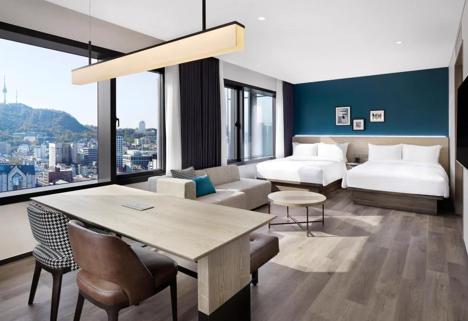 Twin beds and sitting area in a Four Points Josun Myeongdong suite