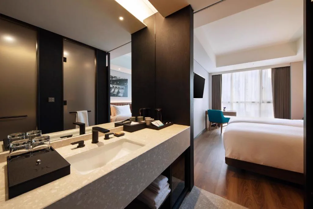 Interior of a guest room and bathroom at Mercure Ambassador Seoul Hongdae