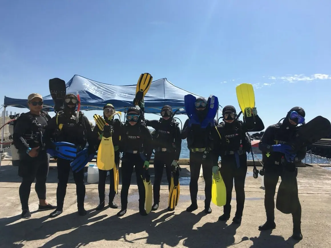 Divers in Jeju preparing scuba equipment on shore