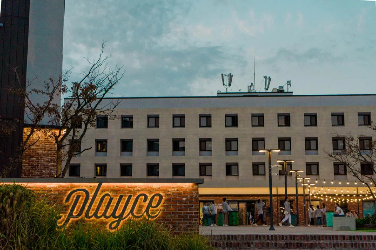 Playce Camp Jeju hotel building with illuminated Playce sign