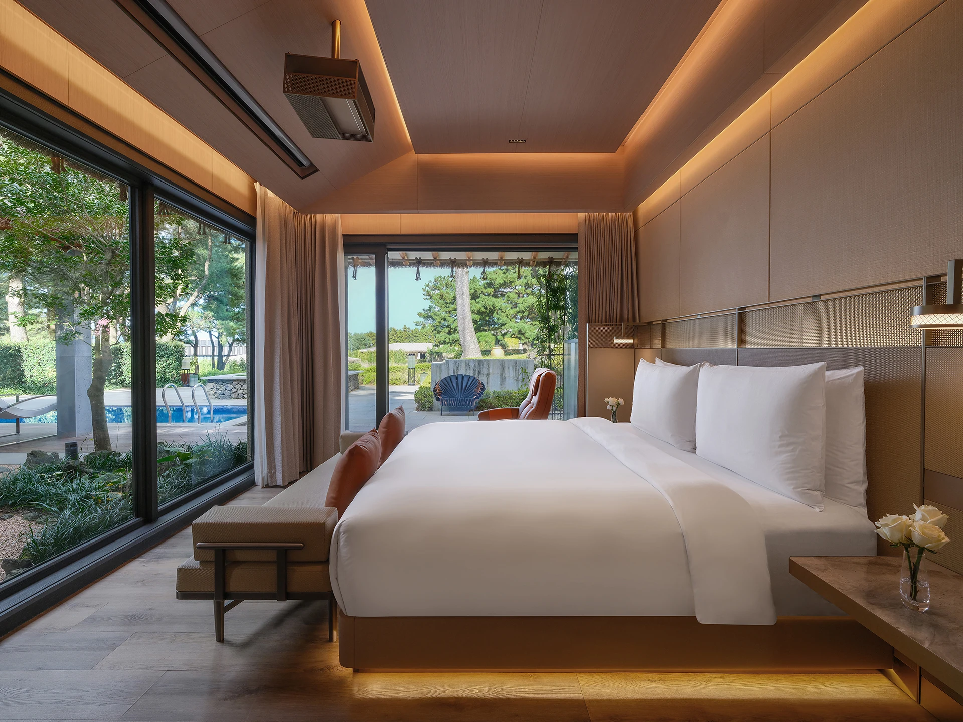 Guest room with a private pool visible beyond the glass doors