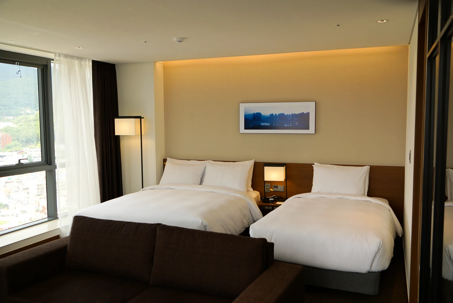 Official guest-room image showing a King bed and a Single bed at Ramada Encore Haeundae.