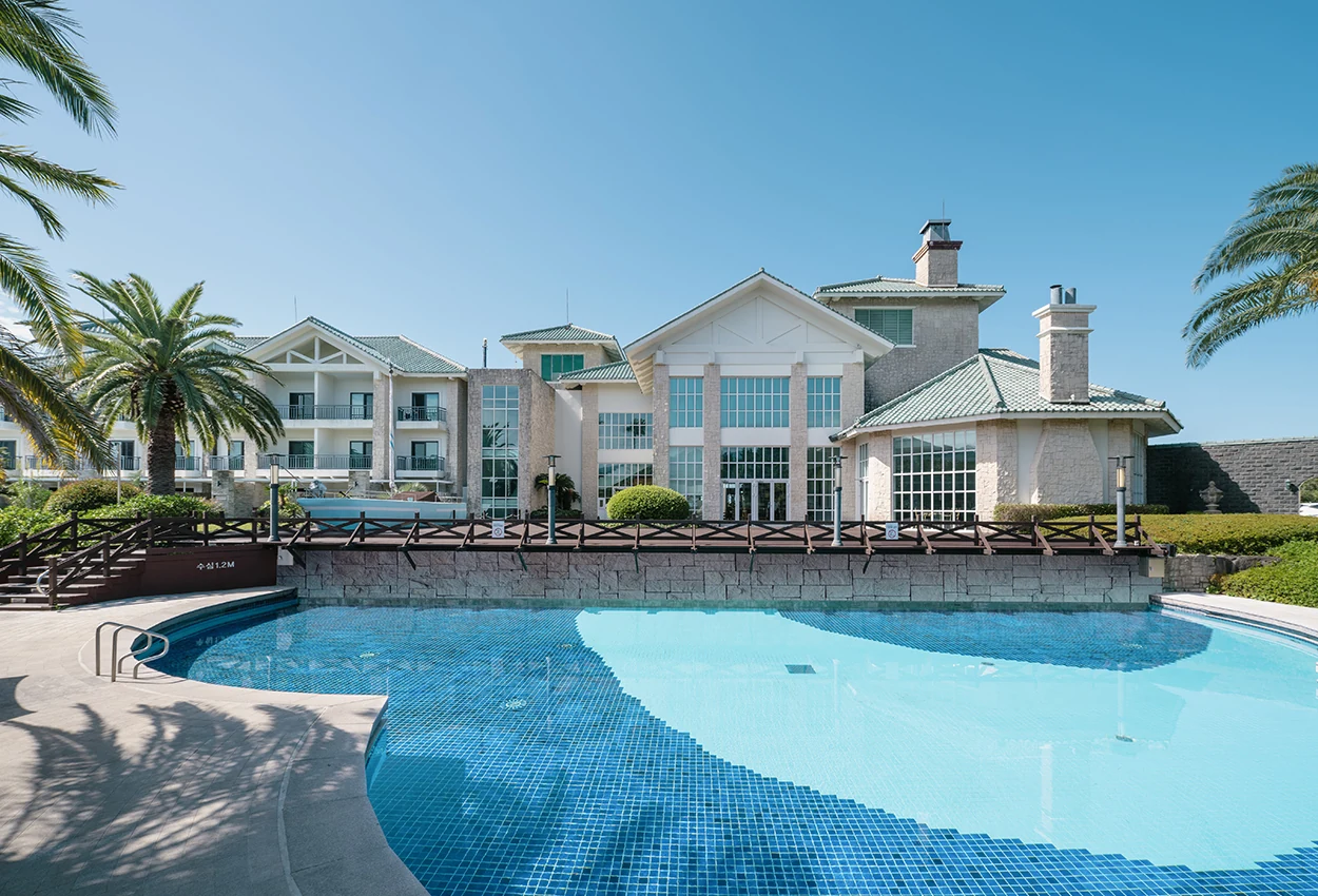 The Suites Hotel Jeju and its shared heated outdoor pool