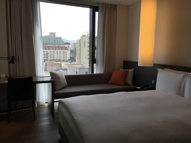 Guest room with a bed and window at Shilla Stay Jeju