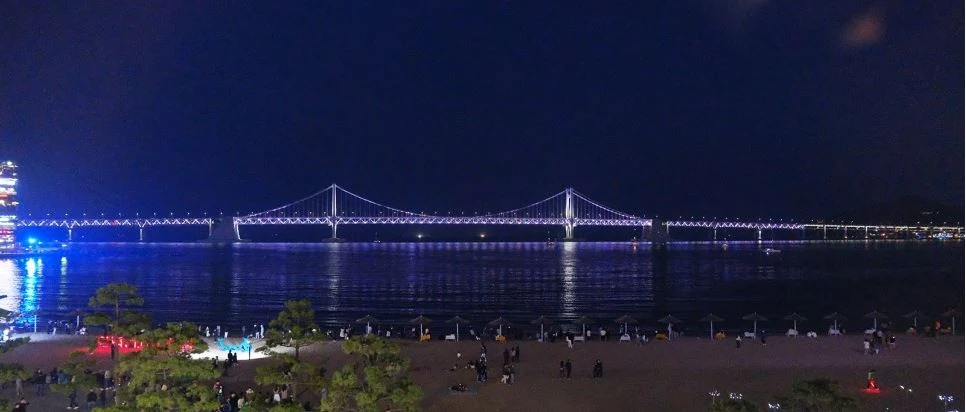 Gwangan Bridge across the water at night, viewed from Gwangalli Beach