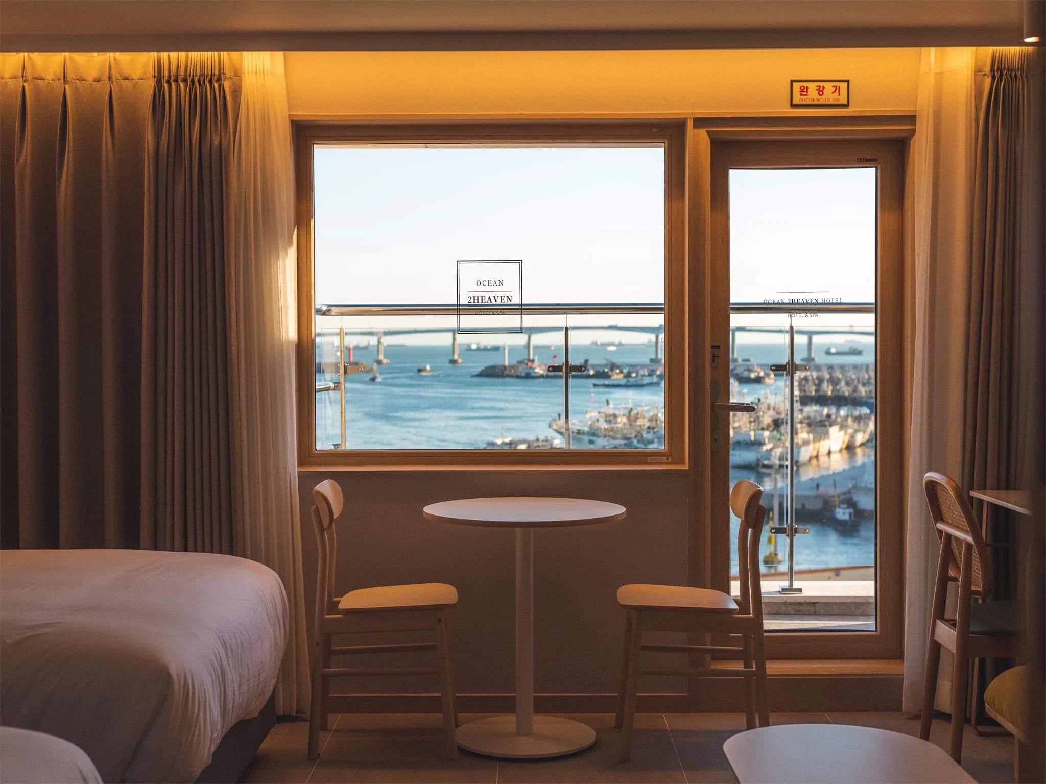 Ocean2Heaven room with a sea-facing window and balcony door