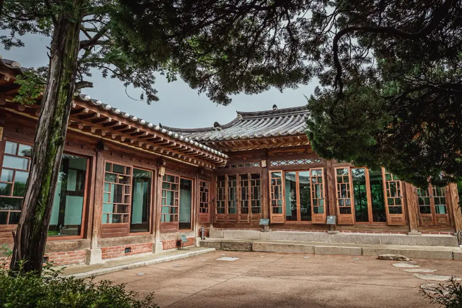 The timber buildings, tiled roofs and courtyard inside Baek In-je House in Bukchon
