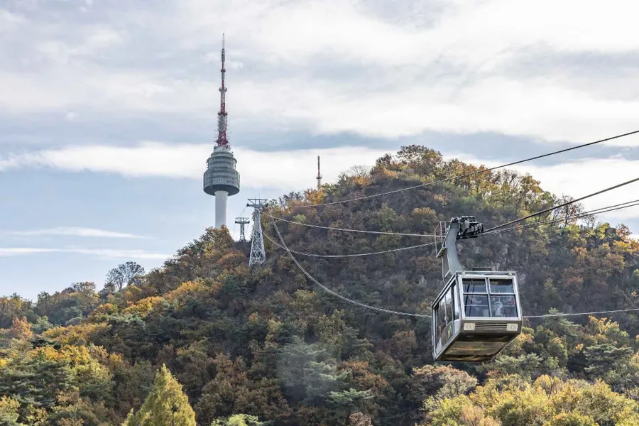 Namsan Cable Car crossing the wooded slope below N Seoul Tower