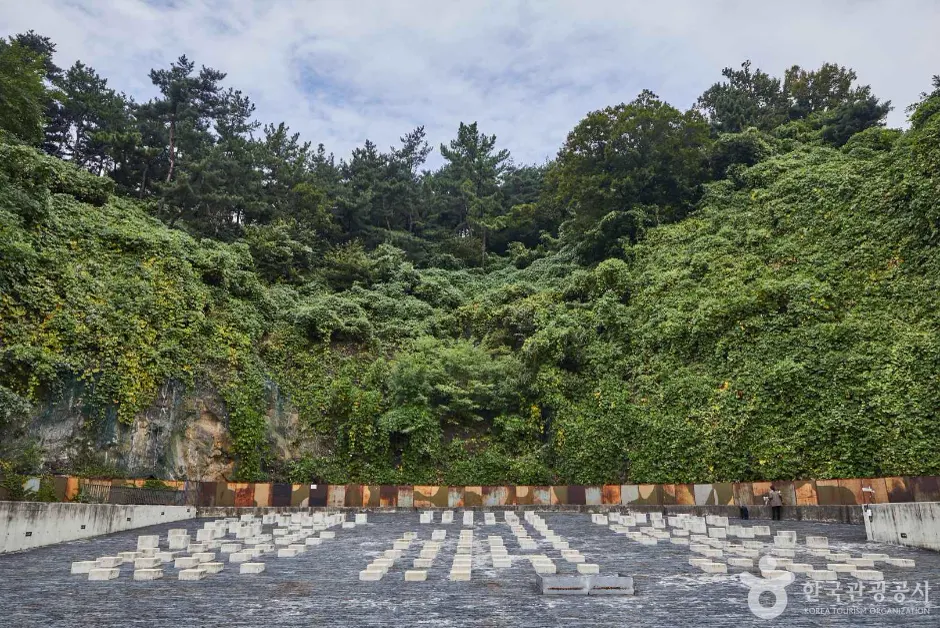 Outdoor plaza and wooded slope at Oil Tank Culture Park